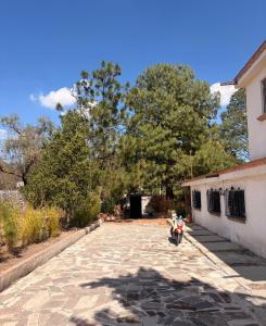 a motorcycle parked in a driveway next to a building at La isla encantada in Aculco de Espinoza +19 photos