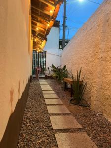 a walkway with a bench next to a building at Pousada Maracajaú in Maracajaú