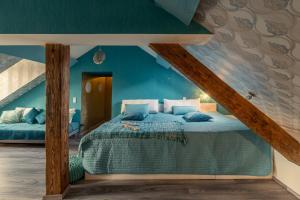 a bedroom with a bed with blue walls at Oriental Cozy Loft - Orientalisches gemütliches Loft in Weibern