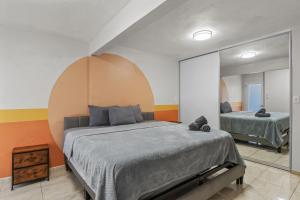 a bedroom with a large bed and a mirror at Perfect Group Retreat for 10 Near Beach & Airport in Carolina +30 photos