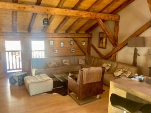 a living room with a couch and a table at Chalet Lucien, Jacuzzi, Les 3 Vallées in Villarly +25 photos