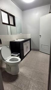 a bathroom with a toilet and a sink at Dan Mai Homestay in Trat