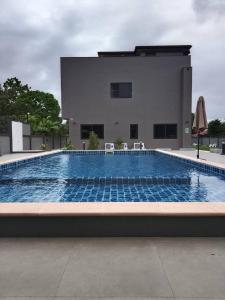 a large swimming pool in front of a building at Dan Mai Homestay in Trat