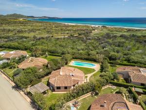 an aerial view of a house and the beach at Villa Del Sole- in Costa Rei