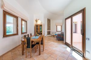 a dining room with a table and chairs at Villa Del Sole- in Costa Rei