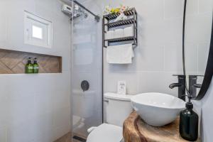 a bathroom with a white toilet and a sink at Perfect Group Retreat for 10 Near Beach & Airport in Carolina