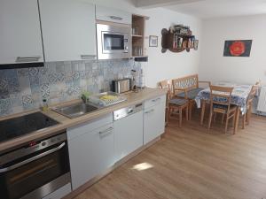 a kitchen with a sink and a counter top at Ferienhaus Rosi in Blankenburg