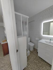 a bathroom with a sink and a toilet and a mirror at Vistal Mar in Puerto de Sagunto +29 photos