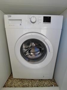 a white washer and dryer in a room at Vistal Mar in Puerto de Sagunto