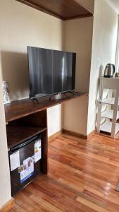 a living room with a large flat screen tv at Margaritas y Soles Petit Hotel in San Miguel del Monte