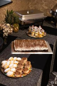 a table topped with two plates of cakes and pastries at Or Haganuz in Dobrovelychkivka +32 photos