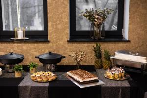 a table with cakes and other pastries on it at Or Haganuz in Dobrovelychkivka