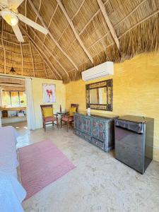 a living room with a table and chairs and a ceiling at Tia Adriana in Sayulita