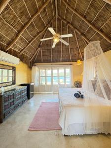 a bedroom with a bed and a ceiling fan at Tia Adriana in Sayulita +61 photos