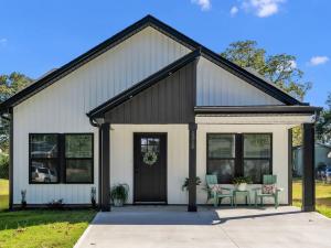 a house with a black and white at 3 BR Downtown Spartanburg- Upscale& Work Ready "Sweet Carolina Cottage" in Spartanburg