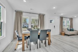 a dining room with a table and chairs at 3 BR Downtown Spartanburg- Upscale& Work Ready "Sweet Carolina Cottage" in Spartanburg