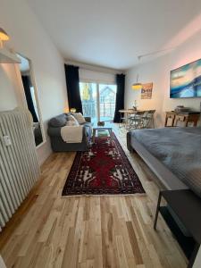 a bedroom with a bed and a couch and a table at Balcony Apartment - Lyngby Great Copenhagen in Kongens Lyngby