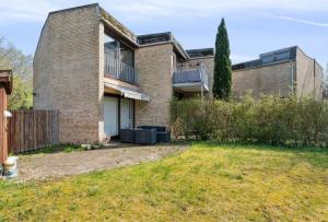 a brick house with a yard in front of it at Balcony Apartment - Lyngby Great Copenhagen in Kongens Lyngby