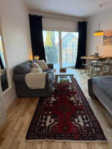 a living room with a couch and a rug at Balcony Apartment - Lyngby Great Copenhagen in Kongens Lyngby