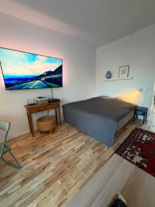 a bedroom with a bed and a desk and a tv at Balcony Apartment - Lyngby Great Copenhagen in Kongens Lyngby