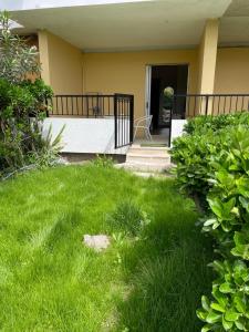 a porch of a house with a grass yard at Nafsikas apartment 2 in Kanoni