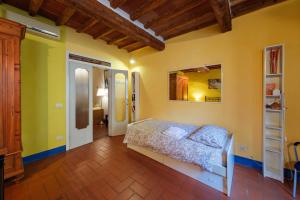 a bedroom with a bed in a room with yellow walls at il Giglio di San Giovanni in Florence