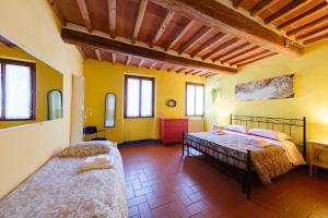 a bedroom with two beds in a room with yellow walls at il Giglio di San Giovanni in Florence +18 photos