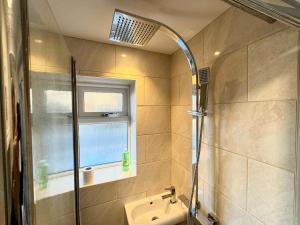 a bathroom with a shower and a sink and a window at Poole Harbour View in Poole +29 photos