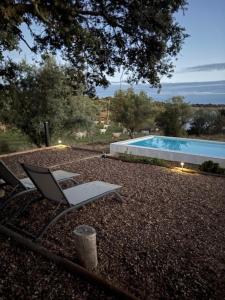 a chair sitting next to a swimming pool at Monte Santo António - Alqueva in Mourão