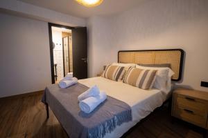 a bedroom with a bed with towels on it at Casa Los Yayos in Segorbe +54 photos