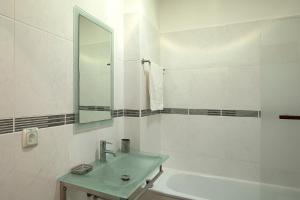 a white bathroom with a sink and a mirror at Solful at the Nomads Village Ponta do Sol in Ponta do Sol +14 photos