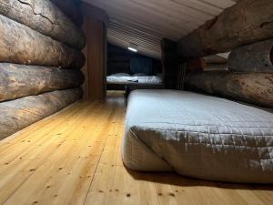 a bedroom with a bed in a room with logs at Ruka Chalet Roma in Ruka