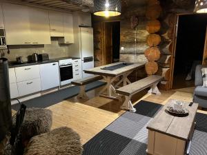 a kitchen with a table and benches in a room at Ruka Chalet Roma in Ruka