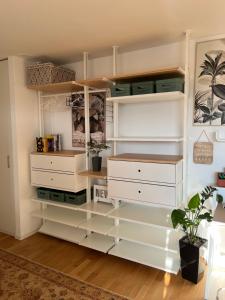 a closet with white drawers and shelves at Studio Horizon Dorigny in Lausanne