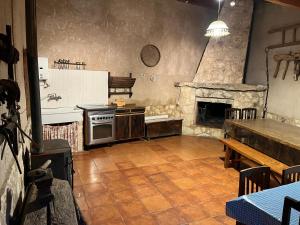 a kitchen with a stove and a stone fireplace at Casa del Herrador I in Carrascal del Río
