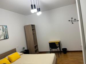 a bedroom with a bed and a desk and a chair at Olympic Lodge in Milan