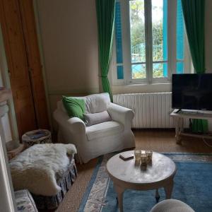 a living room with a couch and a table at La Merlerie in Malicorne