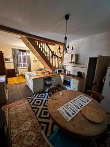 a kitchen with a wooden table in a room at La Merlerie in Malicorne