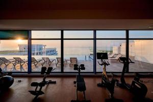 a gym with exercise bikes in front of a large window at Alezzi Infiniti Resort & SPA - SUNRISE 349 in Năvodari