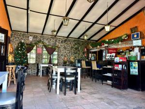 a restaurant with tables and chairs and christmas decorations at Hotel & Restaurant Fleur de Lis in Concepción de Ataco