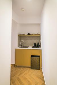 a small kitchen with a sink and a counter at City Breeze Suites in Heraklio +46 photos