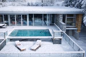 a swimming pool covered in snow next to a house at Villaconcept57 in Abreschviller