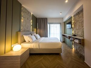 a bedroom with a large bed and a window at City Breeze Suites in Heraklio