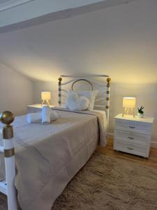 a bedroom with a bed with two lamps on it at Adoria GuestHouse in Adoria