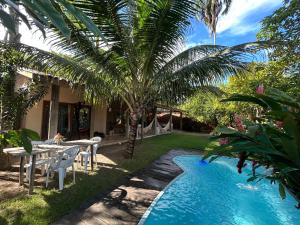 a backyard with a table and a swimming pool at Casa das Alpinias - Trancoso in Trancoso