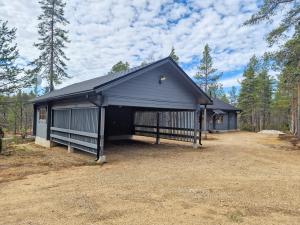 a large black building with a garage at Paratiisikuru 2 in Kakslauttanen