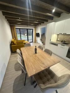 a dining room with a wooden table and chairs at Apartmán Vališka in Horní Bečva