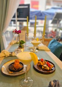 a table topped with plates of food and drinks at The Old Coach Retreat in Rheinfelden