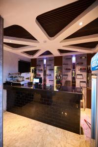 a bar in a restaurant with a counter at Bourdillon Hotel and apartments in Gwarinpa