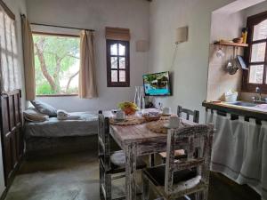a room with a table and a bed and a window at Casas de Juella -Juella-Tilcara in Tilcara